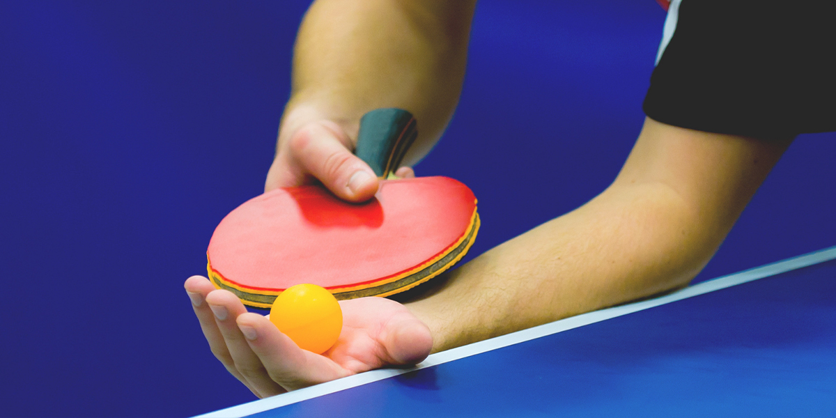 A para table tennis player prepares to serve.