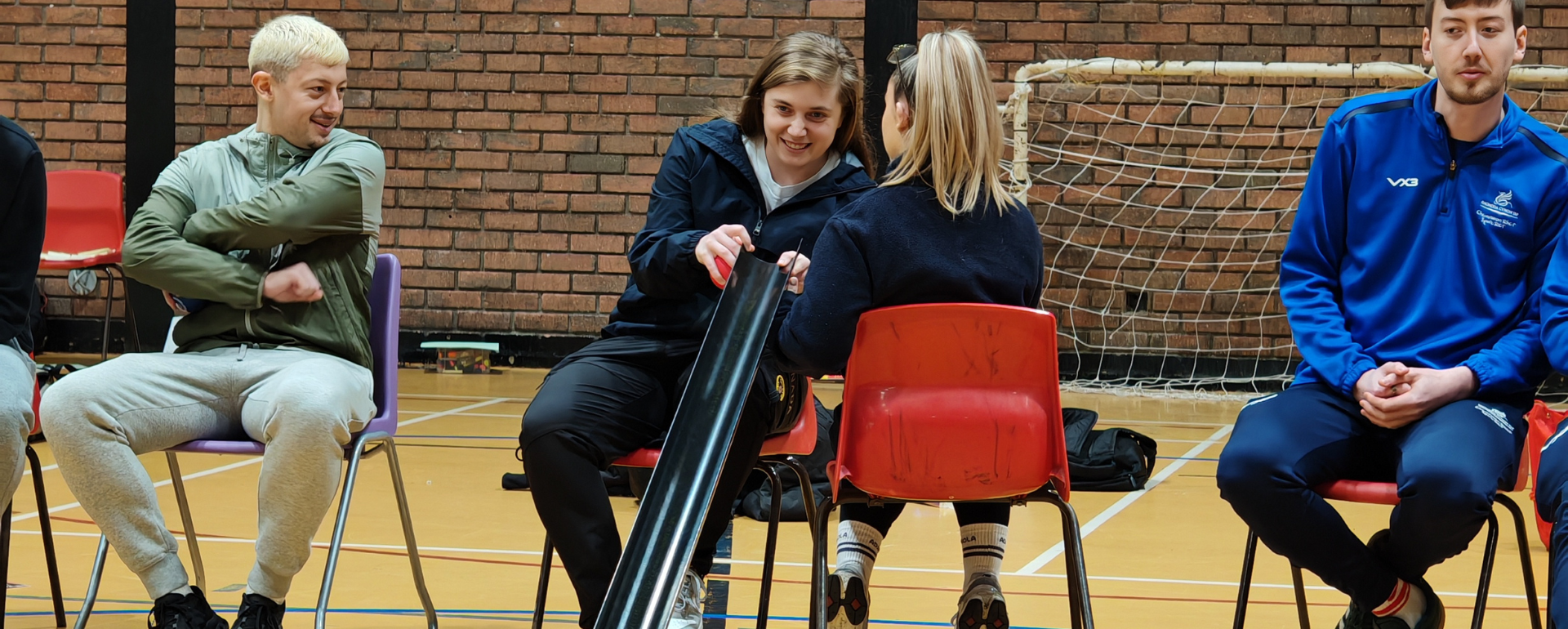 People sat in a line playing Boccia
