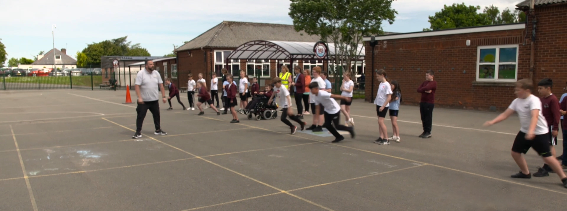 A PE session taking place at a school, inclusive of disabled and non-disabled learners