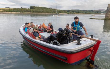 A group of nine people including a wheelchair user cast off in a small motor boat