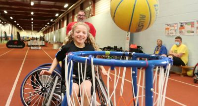 A participant tries wheelchair basketball at an insport Series event