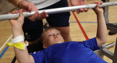 A participant tries powerlifting at an insport Series event