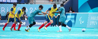 Blind football match between Brazil and Colombia during the Paris 2024 Paralympic Games. Athletes are wearing blindfolds and chasing down the audible ball.