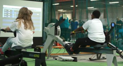 Participants try rowing using rowing machines at an insport Series event