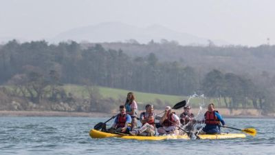A group of kayakers enjoy a trip on the Menai Strait