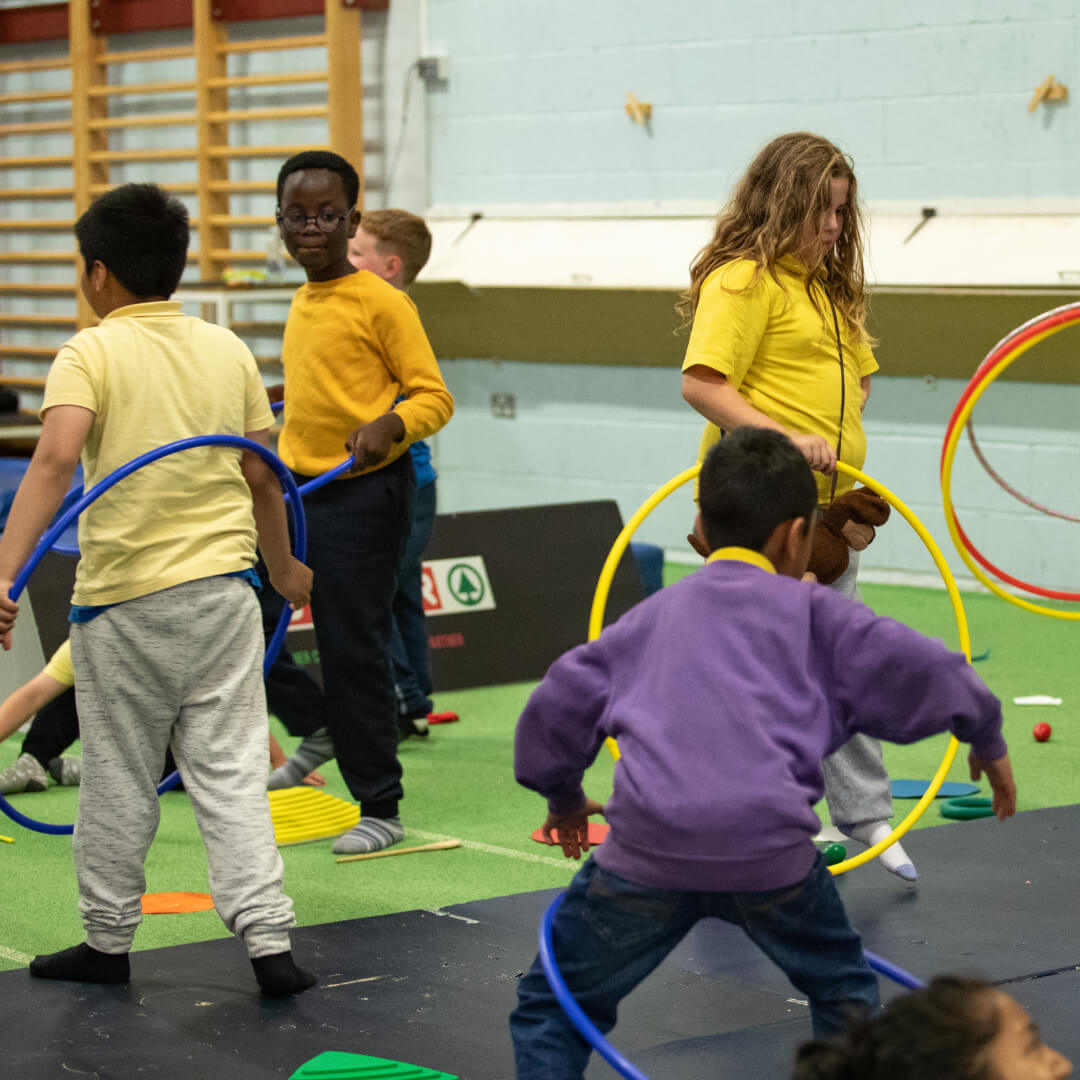 A group of young people try gymnastics.