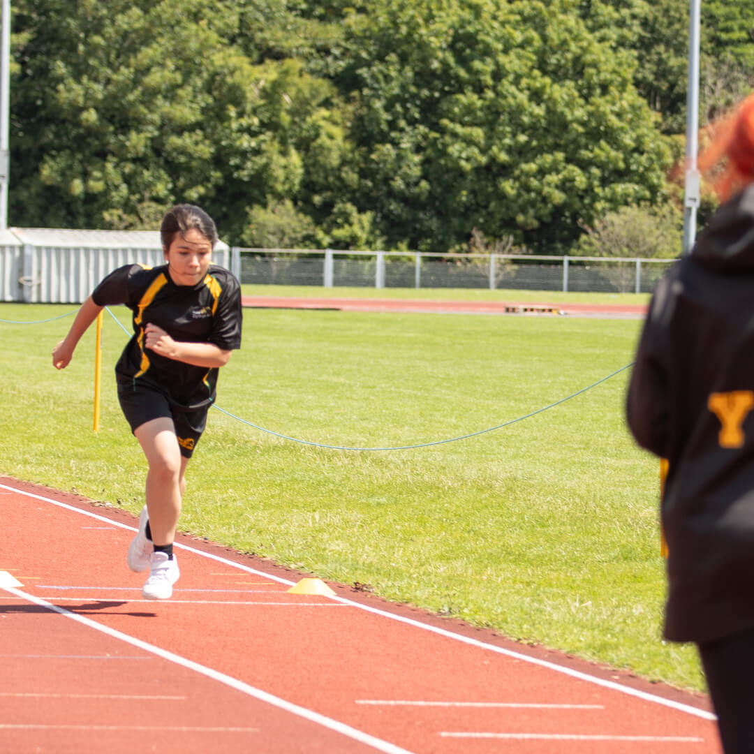 A participant tries athletics on the outdoor track.